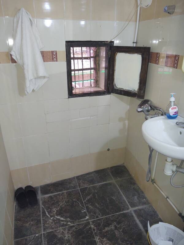 My bathroom in a guesthouse in the Fez el Bali medina: shower, sink, and window.