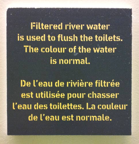 Sign about unfiltered river water used to flush toilets, in the War Museum in Ottawa.