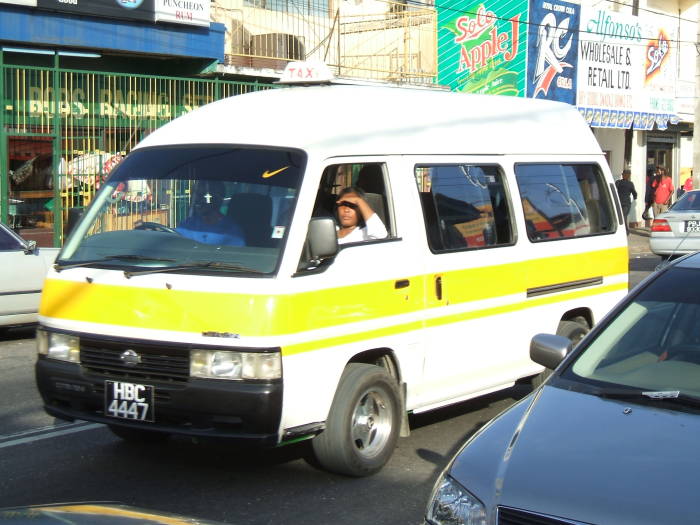 Maxi-taxi shared van moves through Port of Spain, Trinidad.