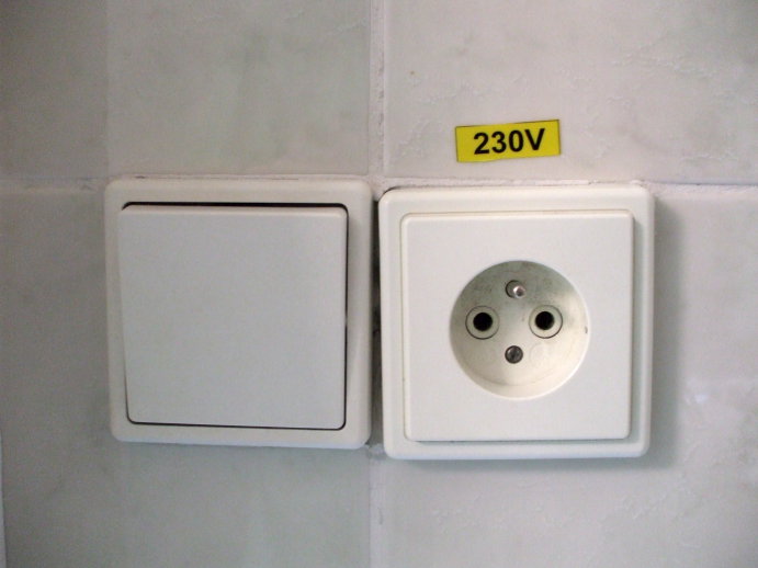 Light switch and grounded outlet in Prague, Czech Republic.