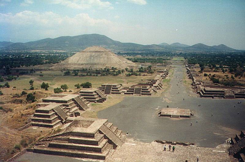 View from Pyramid of the Moon looking out over the Plaza of the Moon and the many smaller ritualistic structures, down the Avenue of the Dead and past the Pyramid of the Sun toward the Temple of Quetzalcoatl.