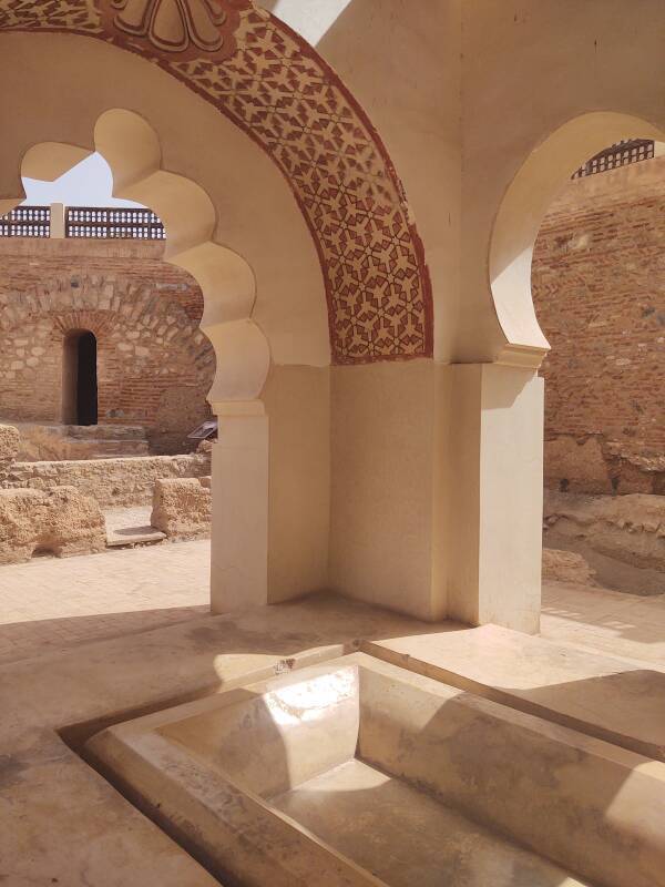 Keyhole arches and marble ablutions basin in the Qubba el-Ba'adiyyin in Marrakech, Morocco.