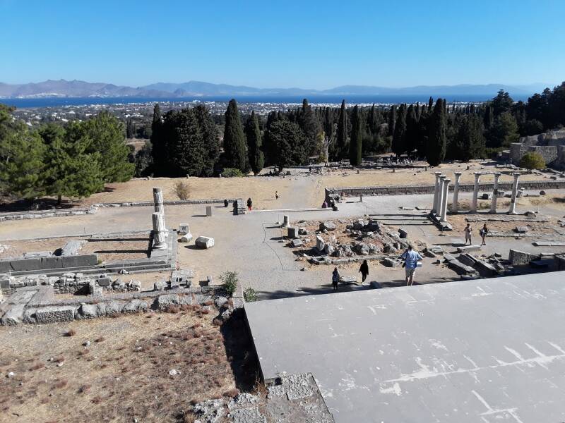 View north from the Second Temple to Asclepius on the Upper Terrace at the Asclepeion. The Middle Terrace and First Terrace, and beyond thoe, Kos town, the strait, and Bodrum, Turkey.