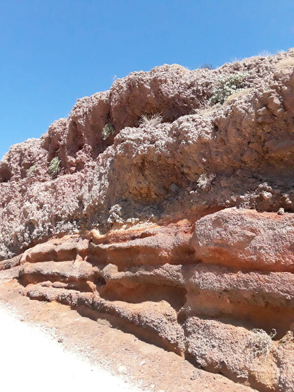 A layer of red deposits near the caldera rim.