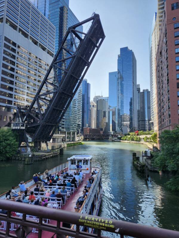 Architectural tour boat passing under the Kinzie Street Bridge over the North Branch of the Chicago River.