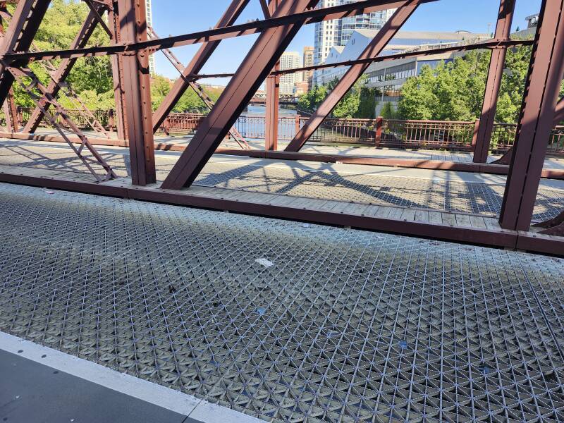 The anti-slip riveted steel grating deck of the Kinzie Street Bridge over the North Branch of the Chicago River.