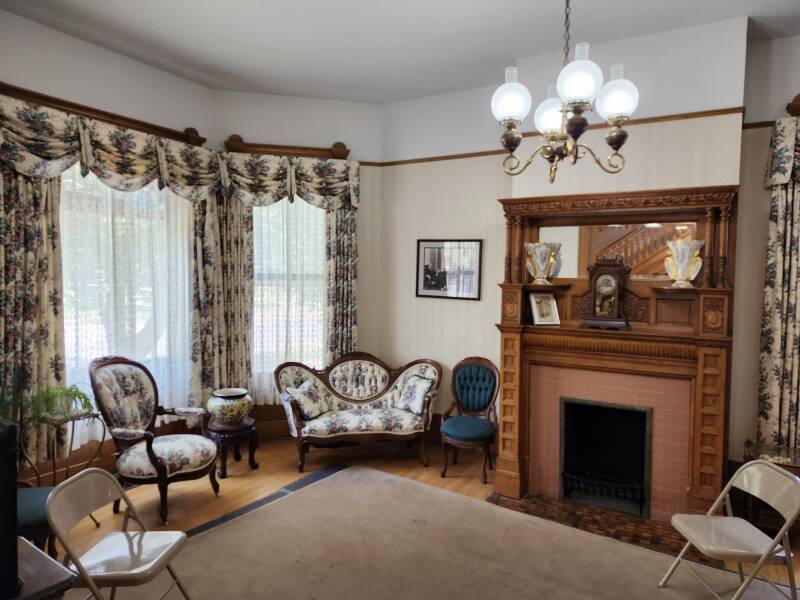 Front parlor with period furniture and one of many fireplaces.