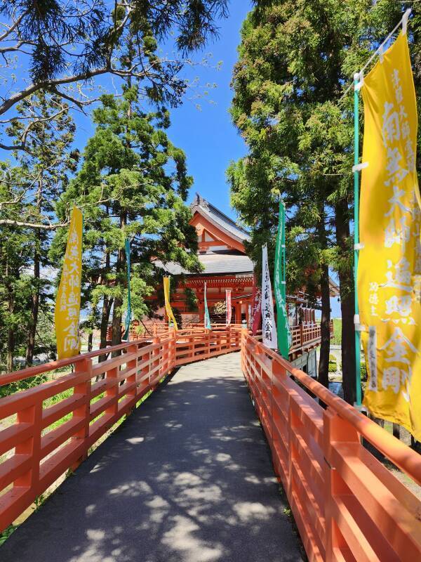 Vermillion railings line an elevated walkway to Kōya-san Aomori Betsu-in.