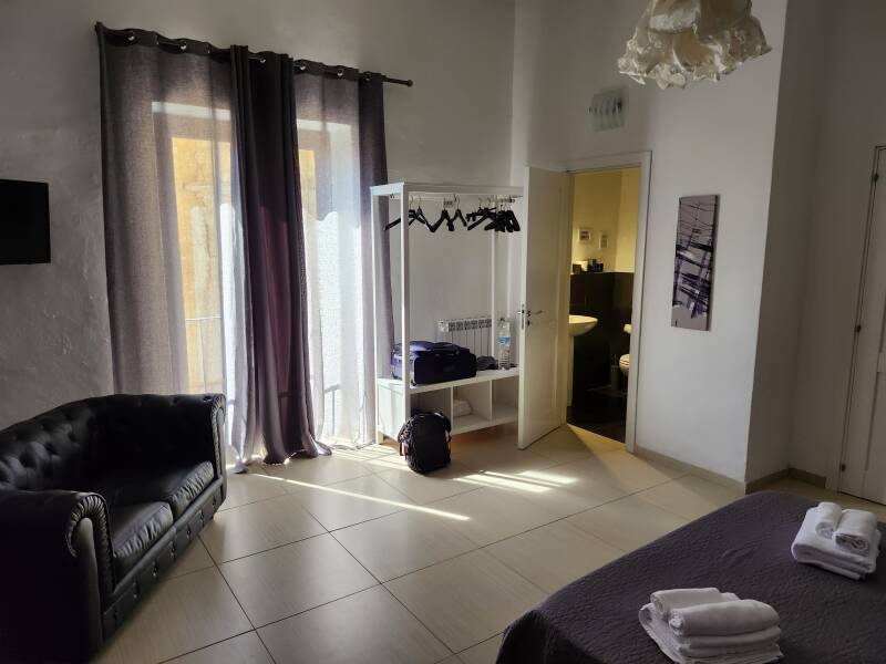 Bedroom and bathroom at Persefone Luxury Suite in Agrigento.