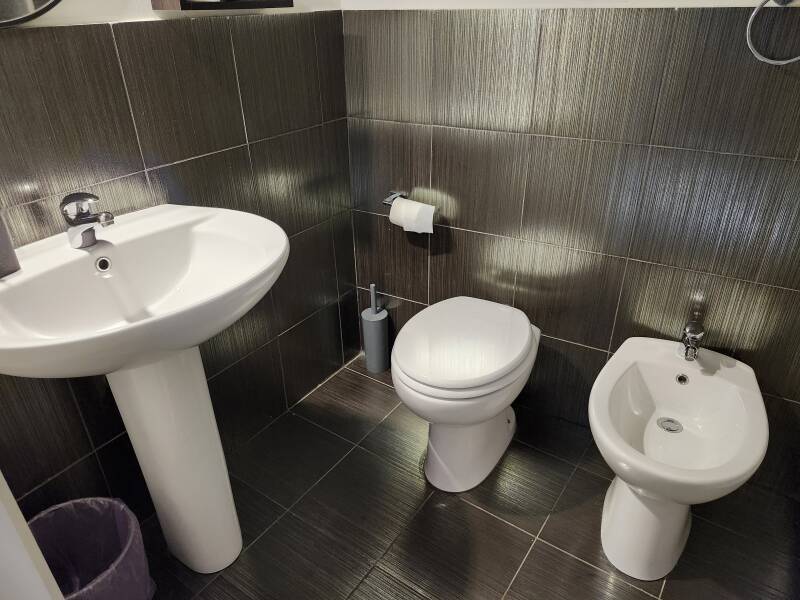Sink, toilet, and bidet at Persefone Luxury Suite in Agrigento.