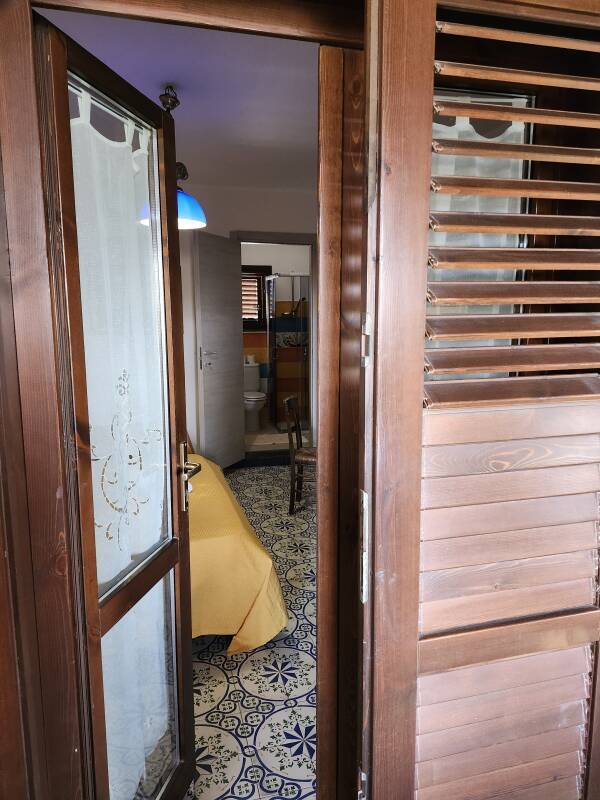 Entry, bedroom, and bathroom at Hotel Al Togo on Vulcano.