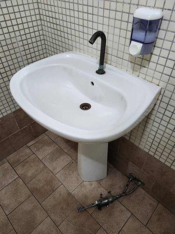 Sink with a foot-controlled water pedal at a restaurant on Vulcano.