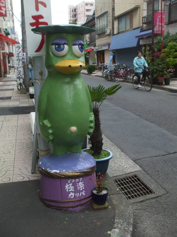 Kappa statue outside a kitchen supply store in Kappabashi-dori or Kitchen Town district of Tokyo.