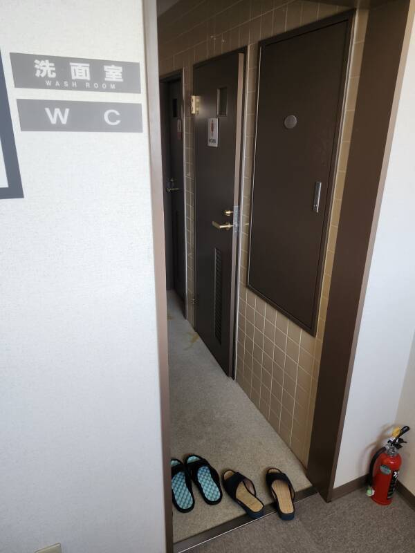 Shared sinks and toilets area in a hotel in Hakodate.