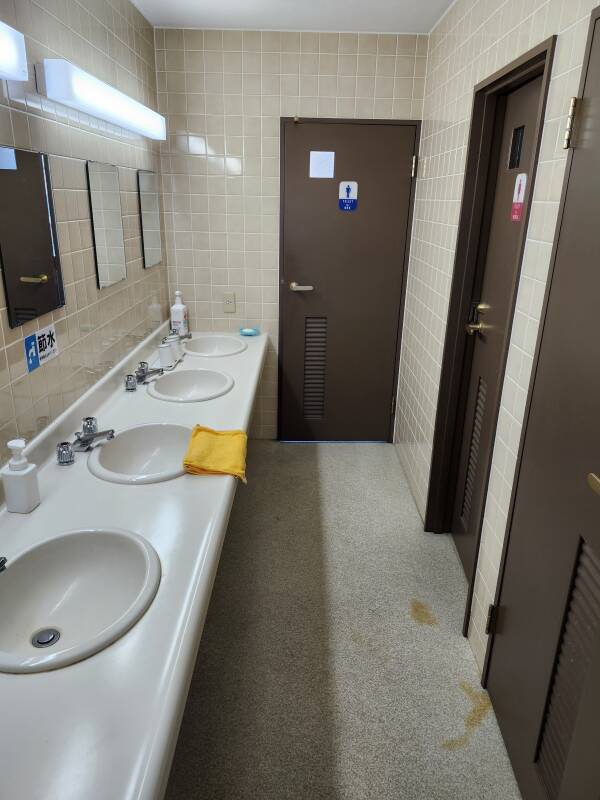 Shared sinks and toilets area in a hotel in Hakodate.