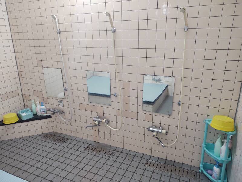 Bath room in a ryokan, three shower points with mirrors.