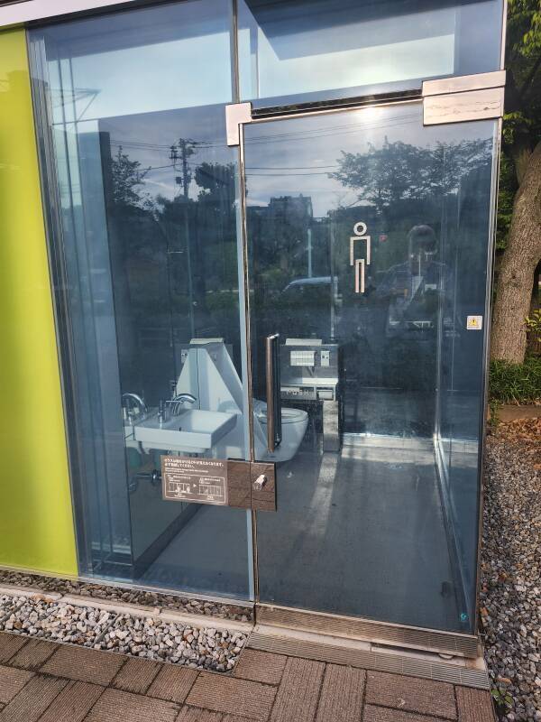 Vacant men's room in a transparent toilet.