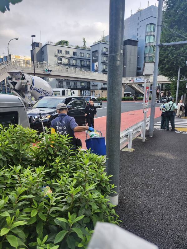 Tokyo Toilet staff leaving Jingūmae Public Toilet after routine cleaning and maintenance.