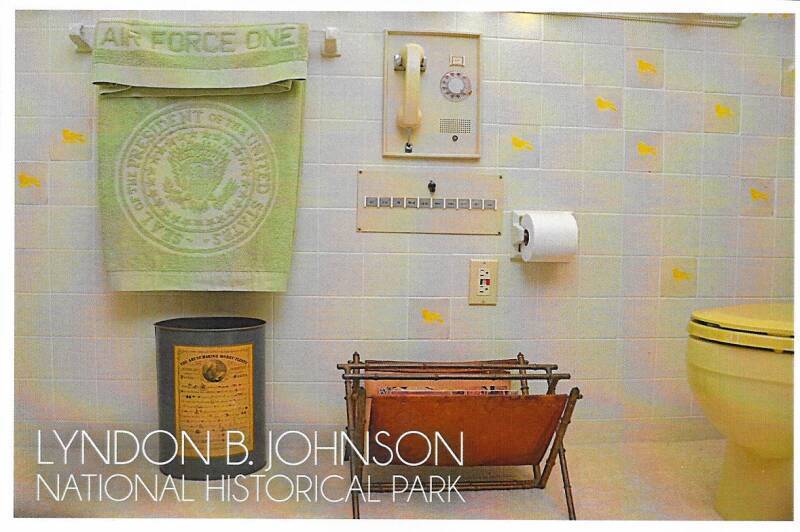 Postcard of the bathroom at the LBJ Ranch: 'Air Force One' towel, multi-line telephone system, and the toilet.