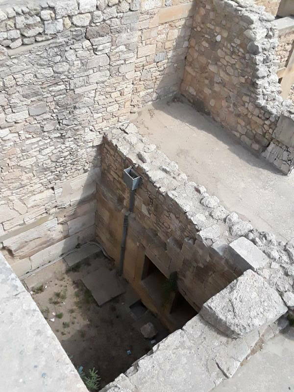 According to the Blue Guide, the Queen's Toilet at prehistoric site of Knossos, outside Iraklia in Crete. However, this is the Court of the Distaffs, a light well.