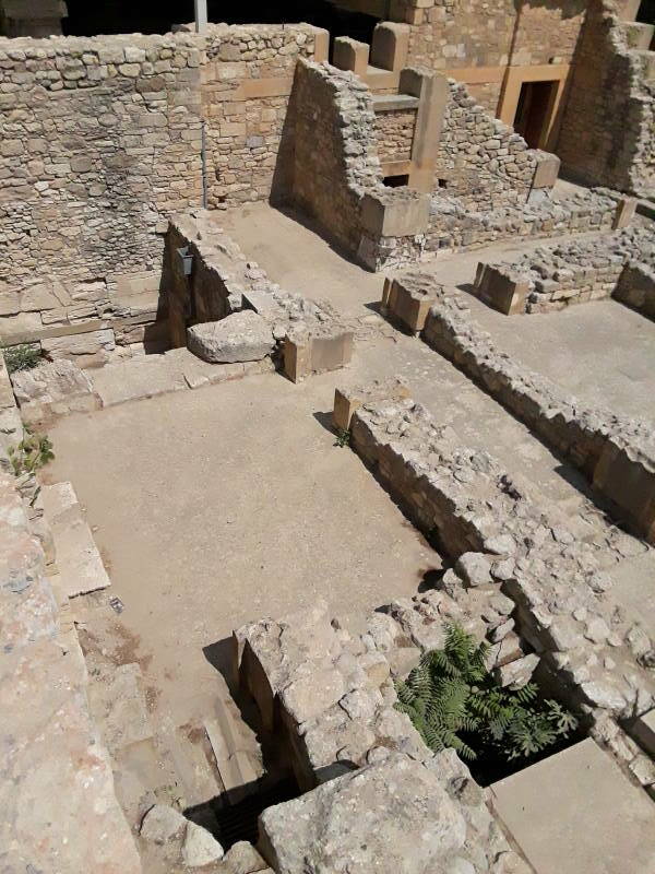 The actual Queen's Toilet at prehistoric site of Knossos, outside Iraklia in Crete. View toward the north-northeast. Light well of the Court of the Distaffs and other rooms, passages, and staircase bases.