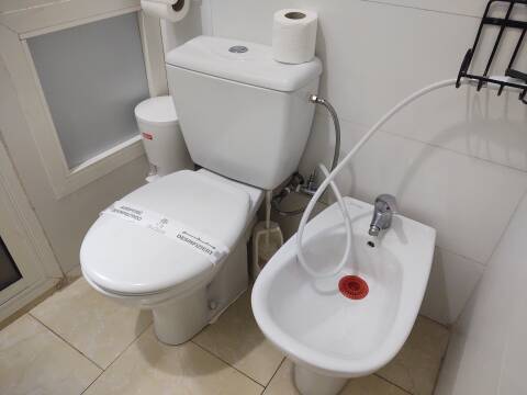Toilet and bidet with an extra shattaf in Casablanca.