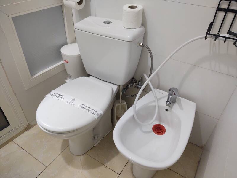 Toilet and bidet in my room at the Hotel Moroccan House in Casablanca. A shattaf, a sprayer on a hose, is connected to the toilet.
