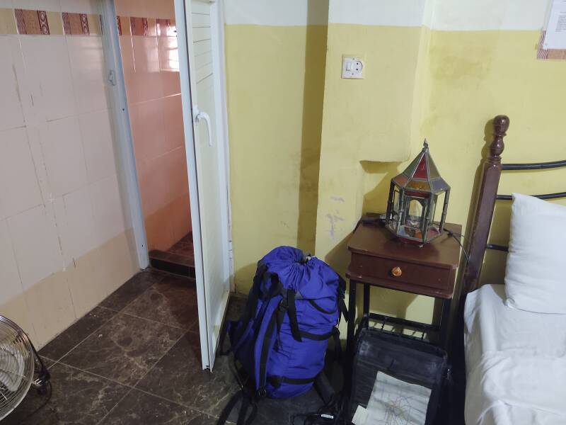 My room in the Fez el Bali medina: bed, backpack, door into bathroom.