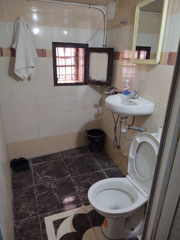 Bathroom in my room in the medina of Fez el Bali: toilet, sink, shower, and window..