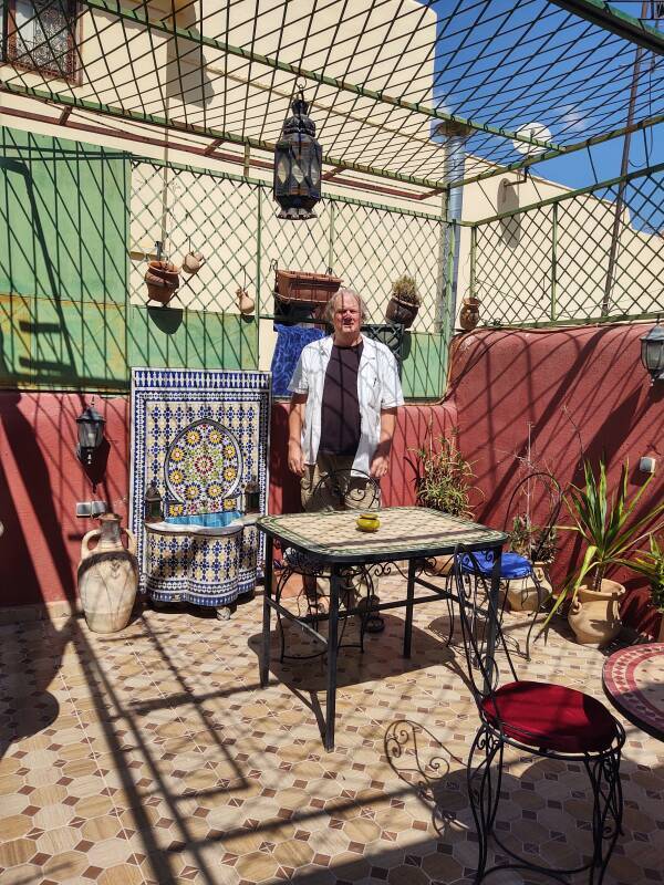 Me next to a small fountain on the rooftop of my guesthouse in the Fez el Bali medina.