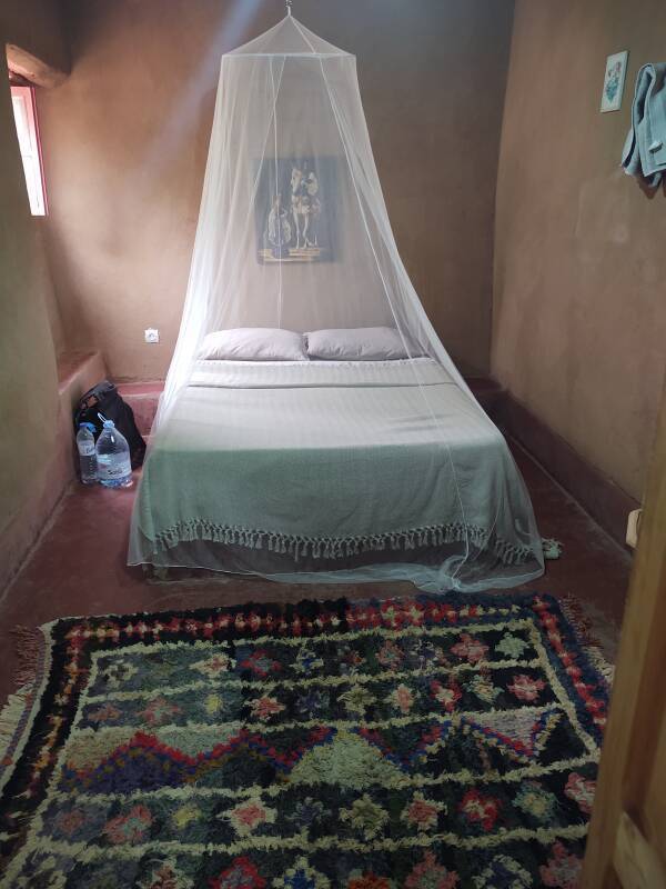 My room with a mosquito net over the bed in M'Hamid.