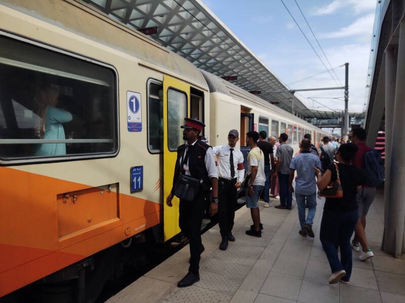 Boarding a passenger train at the station in Kenitra.