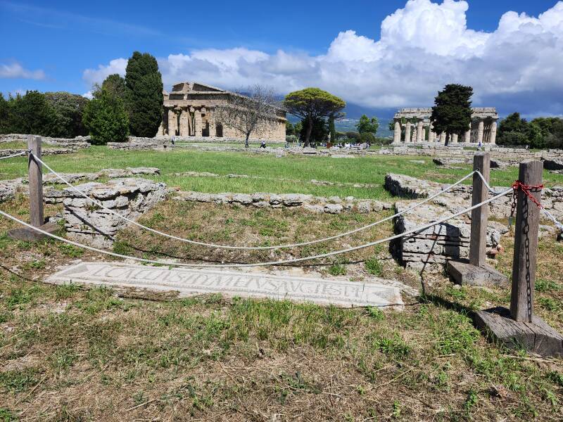 Mosaic at southern bath with temples beyond and mountains in the distance.