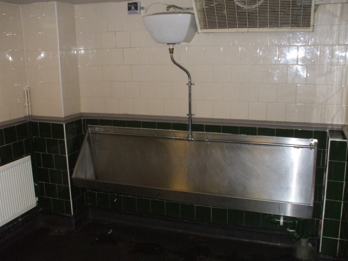 Large stainless steel urinal in a London pub.