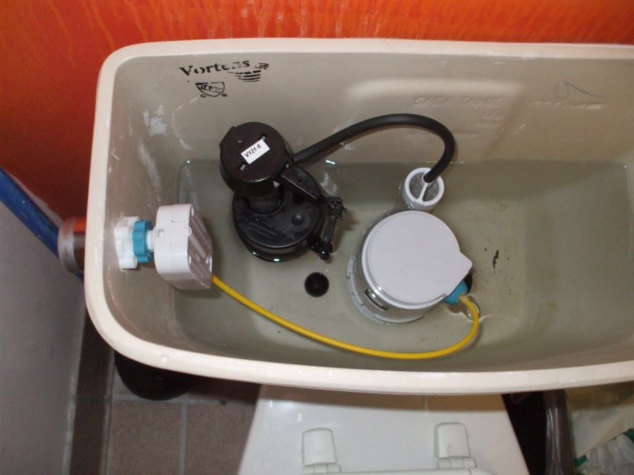 Dual-flush mechanism inside a toilet tank.