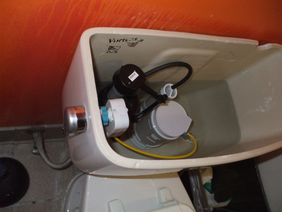 Dual-flush mechanism inside a toilet tank.