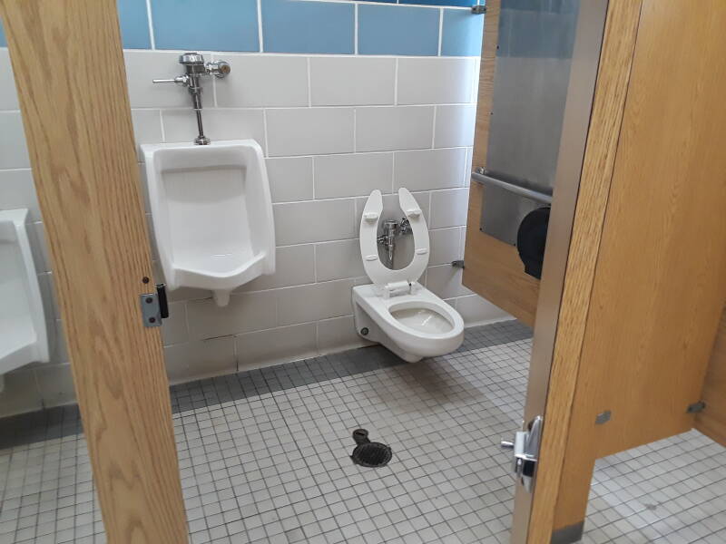 Semi-private dual stall toilet and urinal combination.