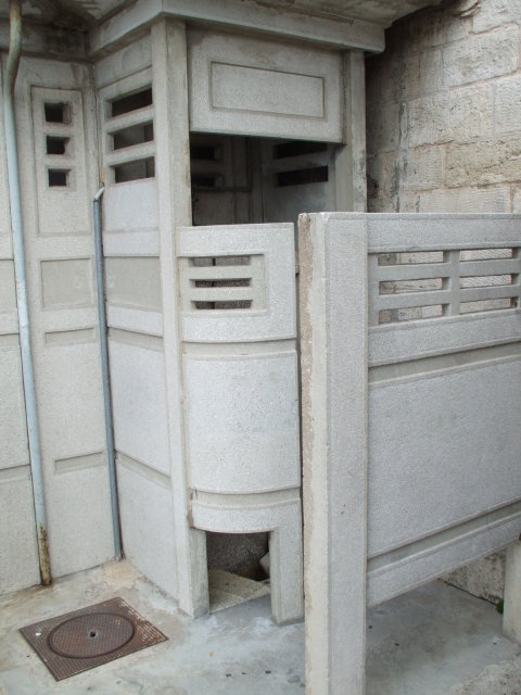 Concrete public urinal in Arles, in the south of France.