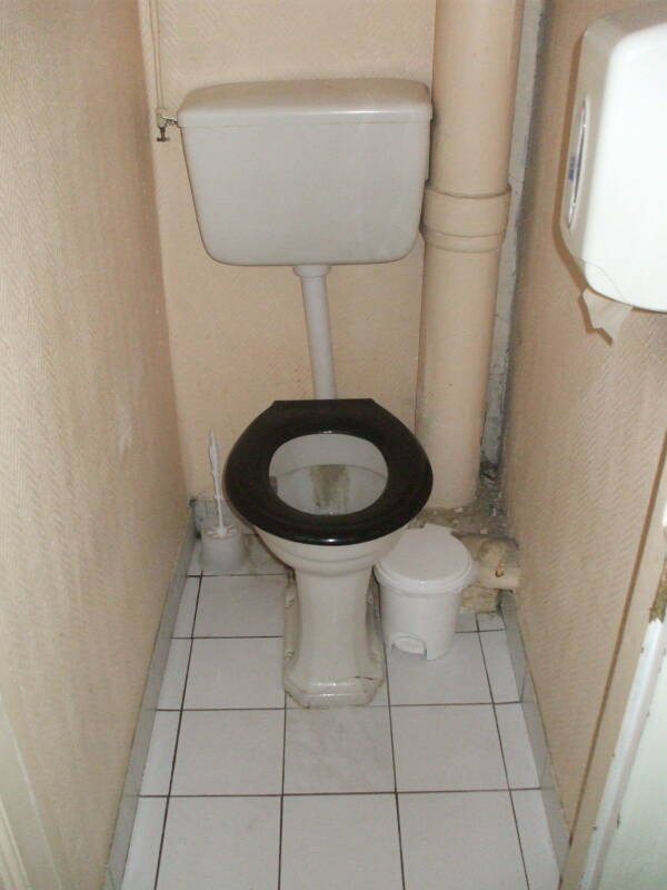 Shared toilet down the hallway in a French hotel.