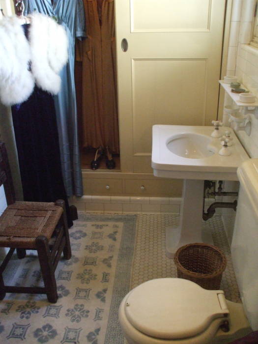 Dressing gown, stool, toilet and pedestal sink at William Randolph Hearst's estate at San Simeon, California.
