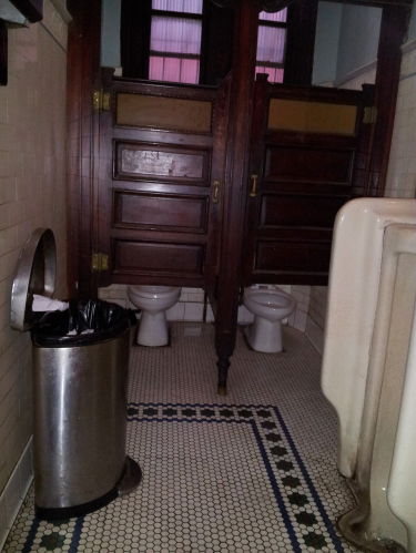 Toilets and urinals inside Old Town Bar on 18th Street in the Flatiron District.