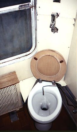 Turkish train toilet and its built-in bidet system, really just a copper water tube.