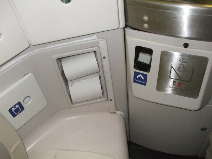Two rolls of toilet paper in an MD-88 airliner lavatory.
