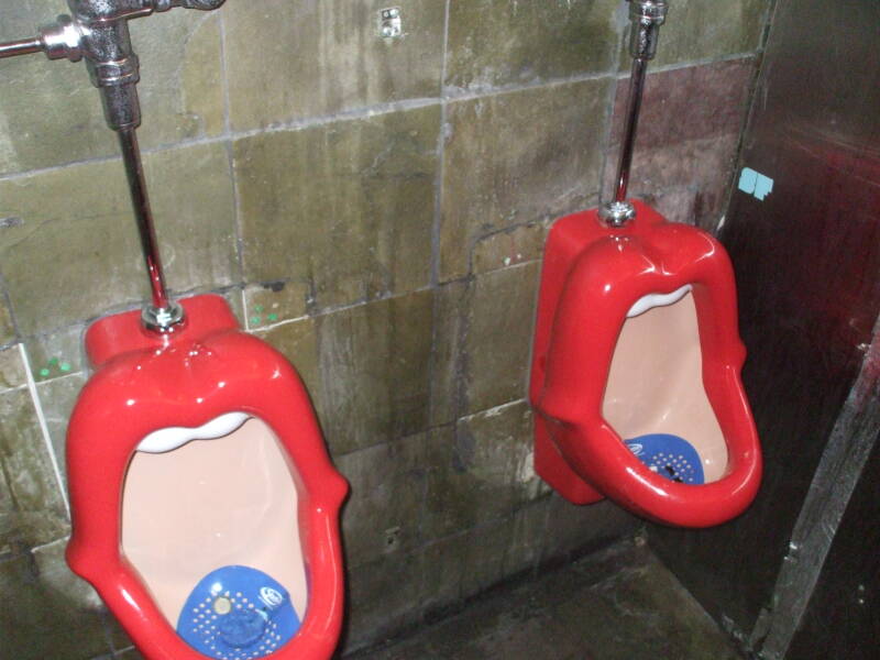 Bright red anthropomorphic urinals at Mehanata Bulgarian nightclub in New York.