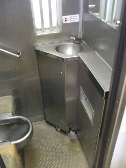 Japanese stainless steel squat train toilet on board the Tobu Railway from Nikko to Minami-Kurihashi.