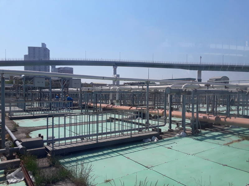 Covered sedimentation and aeration tanks and overhead pipes at the Ebie Sewage Treatment Plant in Osaka.