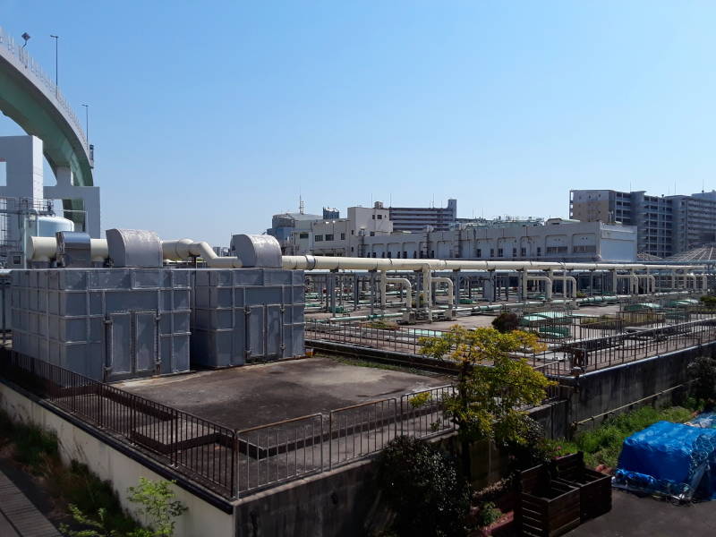 Covered tanks and overhead pipes at Ebie Sewage Treatment Plant in Osaka.