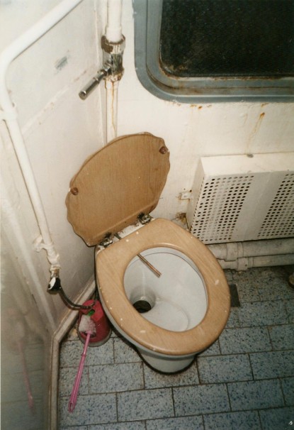 Turkish train toilet with copper water line to wash yourself.