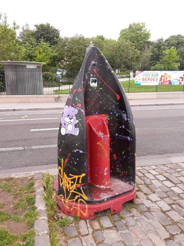 A colorful portable pissoir along the Canal Saint Martin in Paris.