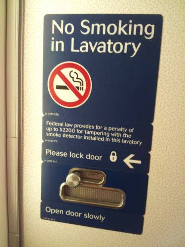 Sign inside a Delta MD-88 lavatory.
